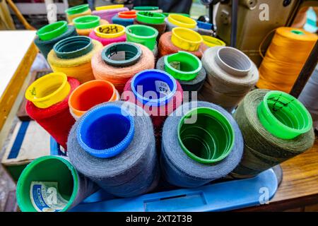 A basket full of coloured sewing threads at a store in George Town, Penang. Stock Photo