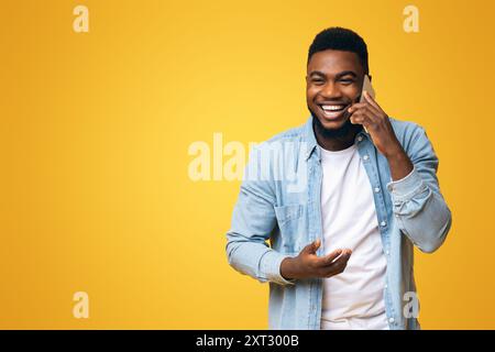 Cheerful black guy talking on phone and laughing out loud Stock Photo
