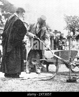 At The School That Has Left A Deep Mark On Great Britain, The Empire, And The World: The King planting his oak at Rugby School, 1909. 'His Majesty [King Edward VII] Shovelling Earth About The Roots Of The Young Tree, In The Close Under The Doctor's Wall. The King...declared open the new Speech Room, commanded an addition to the boys' &quot;hard-earned holidays,&quot; presented prizes. planted a young oak tree in the Close, and inspected the members of the Officers' Training Corps of the school. In the course of his reply to the address read by the head of the school, H. J. B. Clough, a grand-n Stock Photo