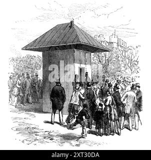 The Thames Subway at Tower-Hill: entrance to tunnel, 1870. Tunnel under the River Thames in London, designed by William Henry Barlow. 'The upper opening of each shaft is covered by a small square building, at the door of which passengers take their tickets, then enter and descend in the lift. On reaching the bottom they find a space of a few feet between the shaft and the buffers fitted up with benches, as a waiting-room... On the railway runs an omnibus conveying twelve passengers...When the omnibus arrives and has discharged its load, those who are waiting step in and start off for the other Stock Photo