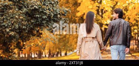 Lovers spending time together in autumn forest, walking by Stock Photo