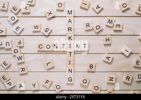 The image is a cross made out of wooden letters, with the word marketing written in the center. The letters are scattered around the cross, with some Stock Photo