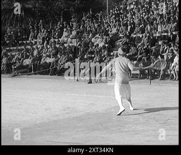 The Tennis Players Suzanne Lenglen of France and Helen Wills of the United States of America Playing a Match With Two Male Civilians in Front of a Large Crowd of People, 1926. From &quot;Time To Remember 1926 - Short Sharp Shower&quot; ( Reel 3); documentary about 1926 - General Strike, international politics, dancing, weather and record breaking feats. Stock Photo