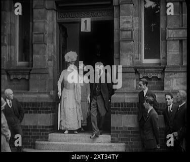 Queen Mary Accompanied by a Group of Officials Emerging from a Building , 1924. From &quot;Time To Remember - A Trip To Europe&quot;, 1924 (Reel 2); a look at political and social life in Europe and beyond during 1924. Stock Photo