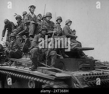 German Soldiers Riding Tanks, 1941. Second World War. Operation Barbarossa was the invasion of the Soviet Union by Nazi Germany. '...over a hundred divisions waited along the frontier of divided Poland, ready to pounce at the Fuhrer's bidding...the twenty-four divisions diverted to conquer Greece and Yugoslavia were moving back to take up their proper stations for the attack on Russia...in all its history, the world had never known such an onslaught...In a few hours, Stalin had lost the better part of his frontline air power. Then, from the Gulf of Finland to Romania, from the Baltic to the Bl Stock Photo