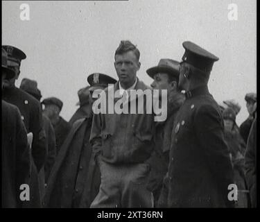 The Pilot Charles Augustus Lindbergh Speaking To Colleagues, 1920s. On 20-21 May 1927 Lindbergh made the first successful solo transatlantic flight from New York to Paris, flying in a single-engined single-seater monoplane that he named 'Spirit of St Louis'. The flight took a total of 33 1/2 hours to complete. For his achievement Lindbergh won a $25,000 prize put up by a New York hotelier, Raymond Orteig, and worldwide fame. From &quot;Time To Remember - Fast And Far  in the Twenties&quot;, 1927 (Reel 3); a look at the obsession with speed and travel during the late 1920s. Stock Photo