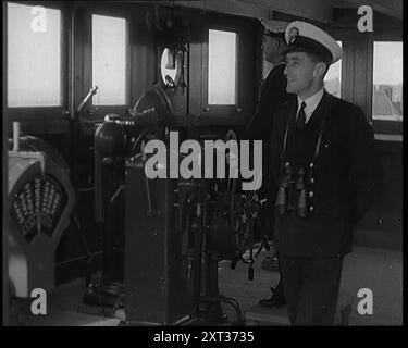 Interior of a Ship at Sea With Men at Work, 1920s. Officer on the bridge of a ship making a transatlantic voyage. From &quot;Time To Remember - Fast And Far  in the Twenties&quot;, 1927 (Reel 3); a look at the obsession with speed and travel during the late 1920s. Stock Photo