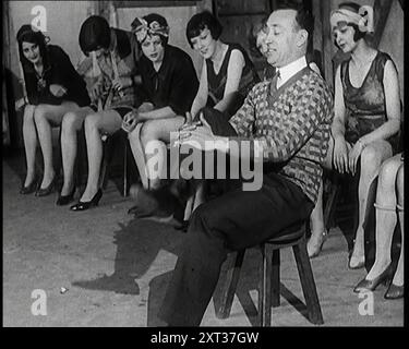 A Group of Dancers in Training Doing Exercises, 1920s. From &quot;Time To Remember - On Stage In The Twenties&quot;, 1927 (Reel 1); a look behind the scenes of the theatre during the 1920's. Stock Photo