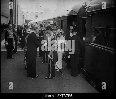 King George VI and Queen Elizabeth of Britain Being Greeted in Paris at Bois de Boulogne Train Station by the French President Albert Le Brun and His Wife Marguerite Le Brun and Officials During the Royal State Visit to France, 1938. From &quot;Time To Remember -  Wind up Week&quot;, 1938 (Reel 2); documentary film about 1938 - people become aware of the growing threat of war. Stock Photo