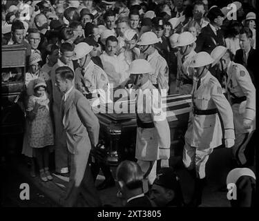 Male American Soldiers in White Uniforms Carrying the Coffin of Anton Cermak, the Mayor of Chicago, 1933. USA. 'When the president-elect [FDR] was visiting Miami, Florida, there in the darkness, someone took a shot at him. The culprit was marched off, but though he'd missed his aim, he'd found a target. Miami's Mayor Cermak. So in place of Franklin Roosevelt, Mayor Cermak lost his life. It is reported that before he died, one of the last things he said was: &quot;I'm glad that it was me&quot;.' From &quot;Time To Remember - Around the Corner&quot;, (Reel 4); diary of events in 1932-1933 in the Stock Photo