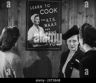 An Information Film Showing Women Looking at a Recruitment Poster for Female Army Cooks, 1942. Britain during the Second World War: poster reads: Learn to cook; the A.T.S., [Auxiliary Territorial Service] W.A.A.F. [Women's Auxiliary Air Force] and W.R.N.S. [Women's Royal Naval Service] need you. 'A call to arms. [Women talking:] &quot;Cooking&quot;. &quot;I want a change&quot;. &quot;I can't cook anyway&quot;. &quot;I want to do something exciting&quot;. &quot;Yes, radio location&quot;. &quot;Or on a gun, or a bomber or something&quot;.' From &quot;Time To Remember - The End Of The Beginning&q Stock Photo