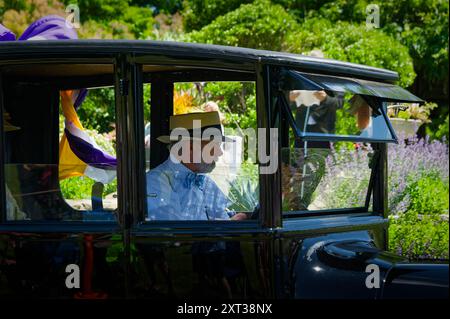 June 2024 American Heritage Museum - Hudson, MA. A driver in a straw hat drives a black Ford Model T in a classic car show. Stock Photo