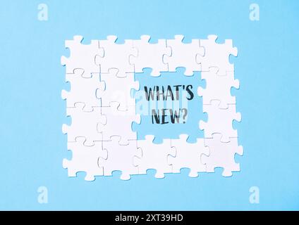 A puzzle with the word What's New? written in the middle Stock Photo