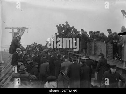 Start of 1st ship, Newark Yards, 1917. Shows Mr. John Hunter of the United States Shipping Board, Mr. Henry R. Sutphen, vice president of the Submarine Boat Corporation and others at a ceremony at the Newark Bay Shipyard, Kearny, New Jersey, December 20, 1917. The ceremony marked the first rivet driven into &quot;the first standardized structural steel ship ever built.&quot; Stock Photo