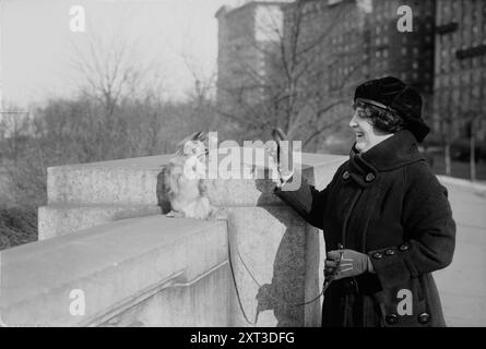 Baker, between c1915 and c1920. Shows American singer and actress Elsie West Baker (1886-1958) with a dog, standing on an overpass on Riverside Drive that goes over 96th Street, New York City. Stock Photo