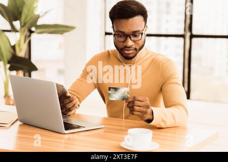 Black business man making purchases using phone Stock Photo