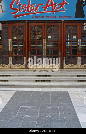 London, United Kingdom - April 04, 2010: Poster Play Sister Act a Divine Musical Comedy at Entrance to Performing Art Theatre. Stock Photo