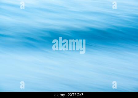 This image captures the serene and mystical movement of ocean waves, artistically blurred to emphasize their motion and fluidity, creating a soothing Stock Photo