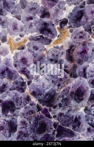 Explore the mesmerizing patterns and deep purple hues of Chevron Amethyst, a unique variation of quartz known for its pointed V-shaped patterns and co Stock Photo