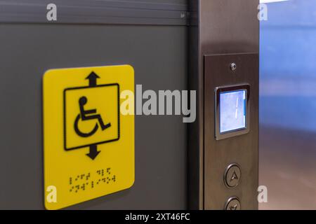 Modern elevator control panel with disabled access and emergency call button in stainless steel interior. An inclusive society. Accessible environment Stock Photo
