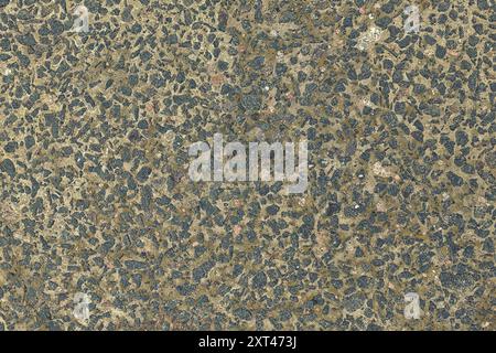 Concrete texture. Pebbles of different colors and signs of aging are visible. Stone wall texture background photo. Stock Photo