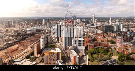 BIRMINGHAM, UK - AUGUST 3, 2024.  An aerial panoramic view of Birmingham cityscape skyline with the HS2 construction site running alongside University Stock Photo