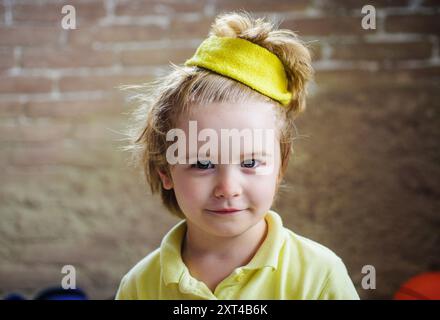 Portrait of cute little boy in yellow t-shirt. Healthy lifestyle, fitness and sport. Smiling kid sportsman in sportswear. Sporty child champion in spo Stock Photo