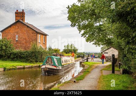 People on canal narrowboats, passing through Hurleston top locks on the Llangollen canal at Hurleston Cheshire England UK Stock Photo