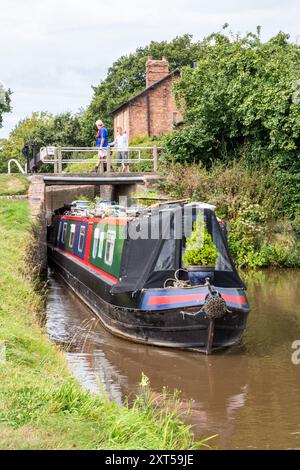 People on canal narrowboats, passing through Hurleston top locks on the Llangollen canal at Hurleston Cheshire England UK Stock Photo