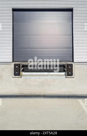 Industrial Loading Dock with Closed Roller Shutter Door Stock Photo