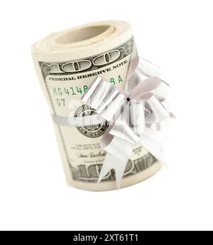 Roll of One Hundred Dollar Bills Tied in a Silver Bow Isolated on a White Background. Stock Photo