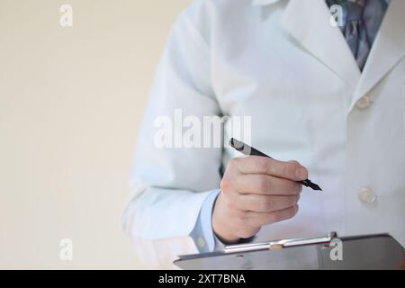 Medical professional taking notes Stock Photo