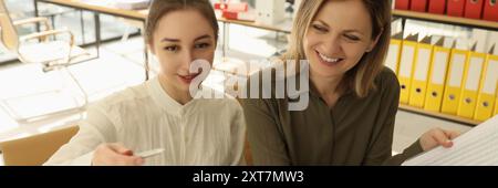 Smiling colleagues discussing new start-up in office Stock Photo