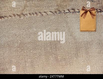 Two pieces of old burlap sewn together with thread. Horizontal background with rustic bag texture Stock Photo