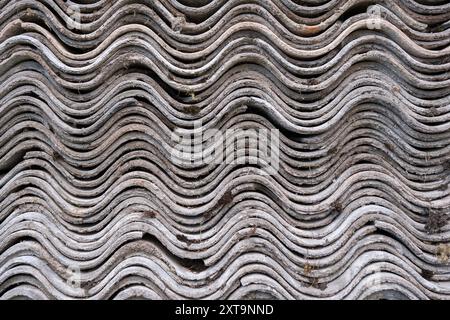 Old and very dangerous asbestos roof. Asbestos dust in the environment. Health problems Stock Photo