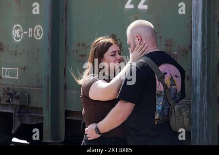 Non Exclusive: KRAMATORSK, UKRAINE - AUGUST 12, 2024 - A Ukrainian serviceman says goodbye to his partner on a railway station platform in Kramatorsk, Stock Photo