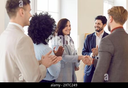 Woman Shaking Hands With Colleague At Office Meeting Stock Photo