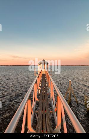 Sunset over Dutch national park Lauwersmeer in Friesland with an ancient lighthouse in front Stock Photo