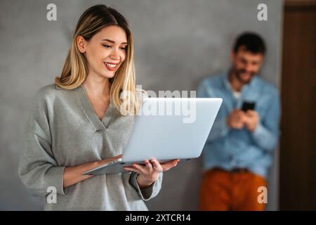 Young female designer, freelancer working in the office. Female using laptop to searching info. Stock Photo