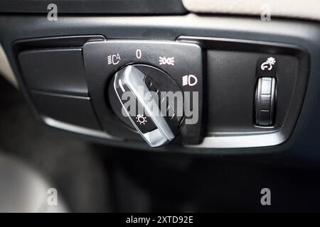 Car interior automotive detailing light switch control button on dashboard. Modern car headlight controls. Stock Photo