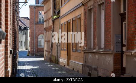 12 August 2024, Brandenburg, Wittstock/Dosse: View of an alley with old buildings and half-timbered houses in the historic town center. Photo: Monika Skolimowska/dpa Stock Photo