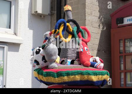 Around Beer a seaside village in South Devon UK. Knitted post box topper celebrating the 2024 Paris Olympics Stock Photo