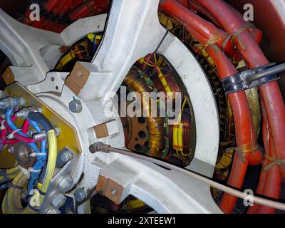 Detailed look at the alternator’s windings and connections, showcasing the intricate setup of an electric generator. Stock Photo