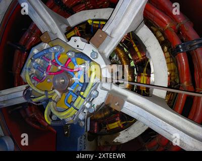 The alternator’s windings and connections are prominently displayed, showcasing intricate cable arrangements and electrical components. Stock Photo