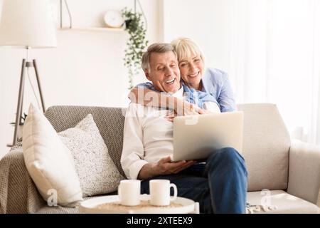 Happy senior couple having video call on laptop Stock Photo