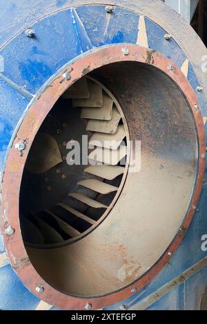 A close-up view of an industrial exhaust fan impeller showing its blades and housing, used for ventilation in an industrial setting. Stock Photo