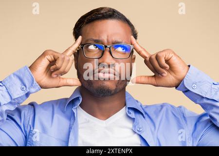 Thoughtful Black Man Concentrating Hard Standing On Yellow Background Stock Photo