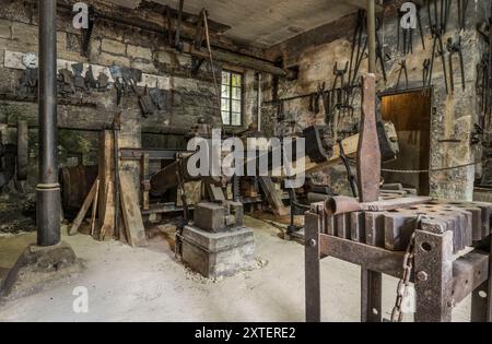 Workshop of a historic hammer mill smithy. Stock Photo