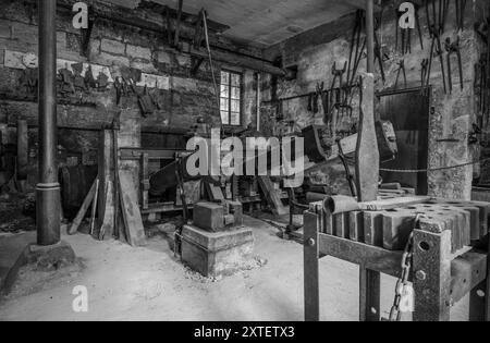 Workshop of a historic hammer mill smithy. Stock Photo
