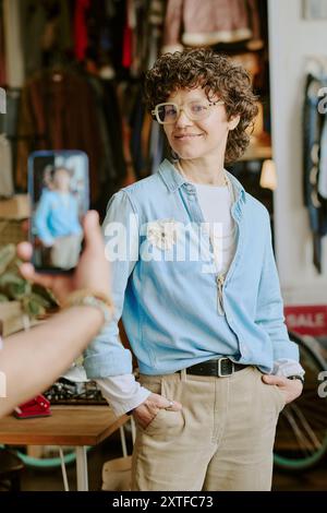 Smiling Woman Posing in Vintage Store Setting Stock Photo